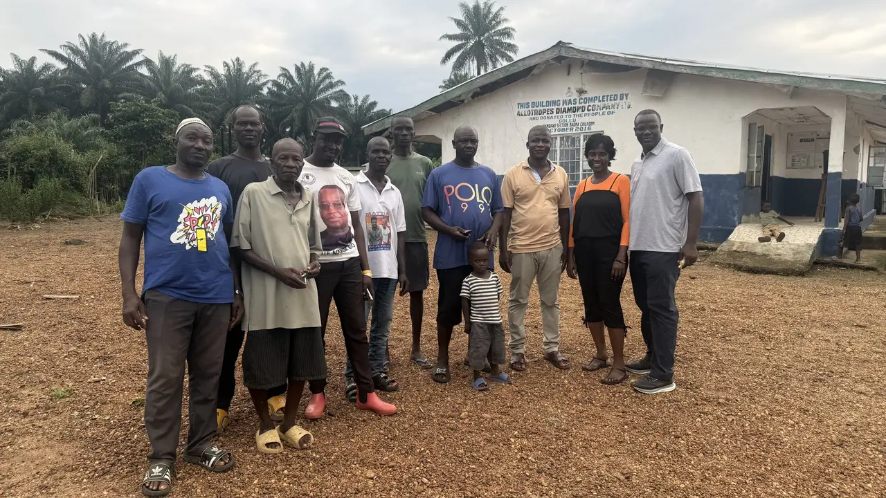 A group gathered outside a building in Ngolu